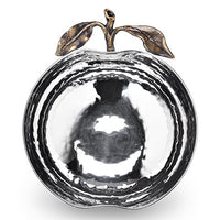 Introducing the Pomona Apple Bowl by Mary Jurek—a gleaming, silver bowl shaped like an apple, featuring a beautifully hammered texture and finished with elegant gold stem and leaf accents on top. Ideal as a festive serving piece for your Rosh Hashanah table, its reflective surface casts captivating patterns of light and shadow.