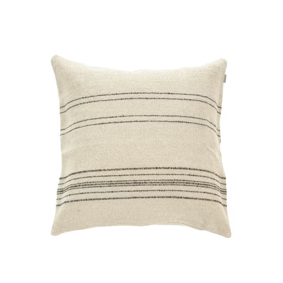 The Moroccan Stripe Pillow by Libeco Home features a square beige design with subtle black horizontal stripes, inspired by traditional Moroccan blankets, shown on a white background.