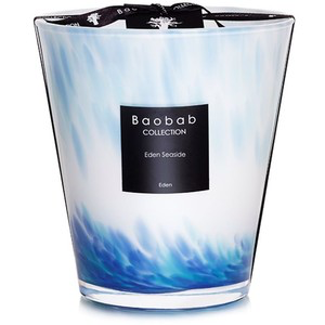 The Baobab Eden Seaside Candle features an opalescent glass holder with blue and white waves inspired by the Mozambique Canal, finished with a black label and ribbon for an elegant touch.