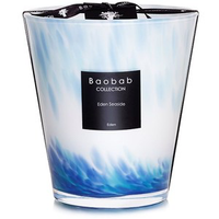 The Baobab Eden Seaside Candle features an opalescent glass holder with blue and white waves inspired by the Mozambique Canal, finished with a black label and ribbon for an elegant touch.