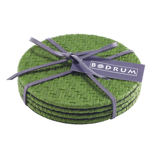 The Bodrum Wicker Easy Care Coaster Set includes four round green woven wicker coasters with felt backing, tied with a gray ribbon and finished with a rectangular Bodrum brand tag.