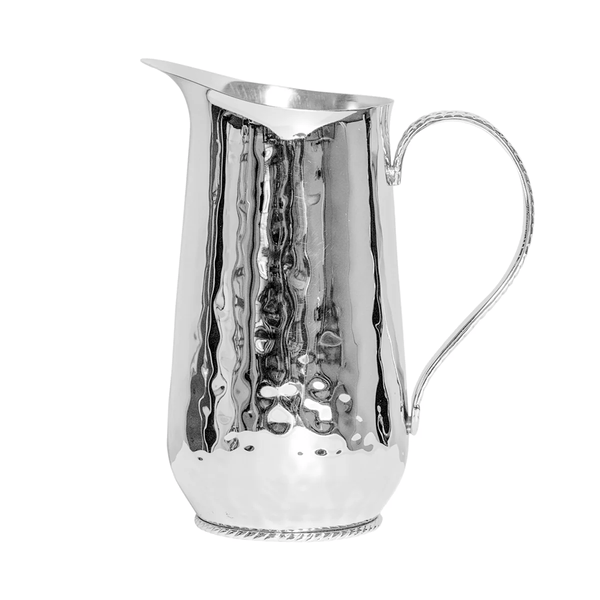 The Juliska Graham Stainless Steel Pitcher features a tall, hammered silver design with a curved spout, slender handle, and decorative base, shown against a plain white background.