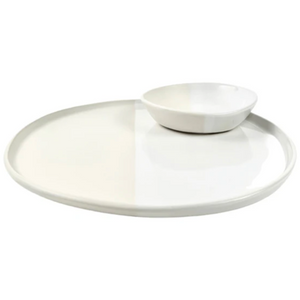 The Alex Marshall Studios Urban Round Platter 13" features a large, modern white design reminiscent of handcrafted artisan pieces—perfect for serving with a smaller bowl on top.