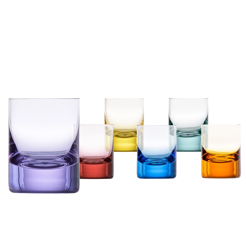 The Whiskey Spirit Glasses S/6 by Moser features six glasses in purple, red, yellow, blue, teal, and orange. Arranged in two rows on a white background, each glass has a transparent upper section with a colored base.