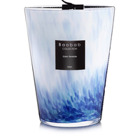 The Baobab Eden Seaside Candle features decorative blue and white marbled glass and a black tag, filling your space with the fresh scent of the South Seas.