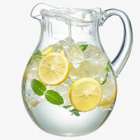 The Wine Savant/Clingbrands Unbreakable Brighton Acrylic Clear Lidded Pitcher (72oz), filled with ice, lemon slices, and mint leaves.