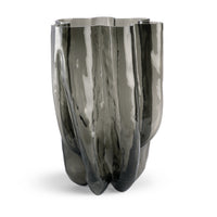 The Hudson Smoke Grey Vase by FlowDecor Inc. features a tall, sculptural design in smoky gray glass with a glossy finish, organic curves, and a wavy rim for striking modern decor.
