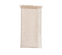 A folded Kim Seybert Chambray Fringe Napkin in Natural, featuring fringed edges on the top and right sides, is displayed against a white background.