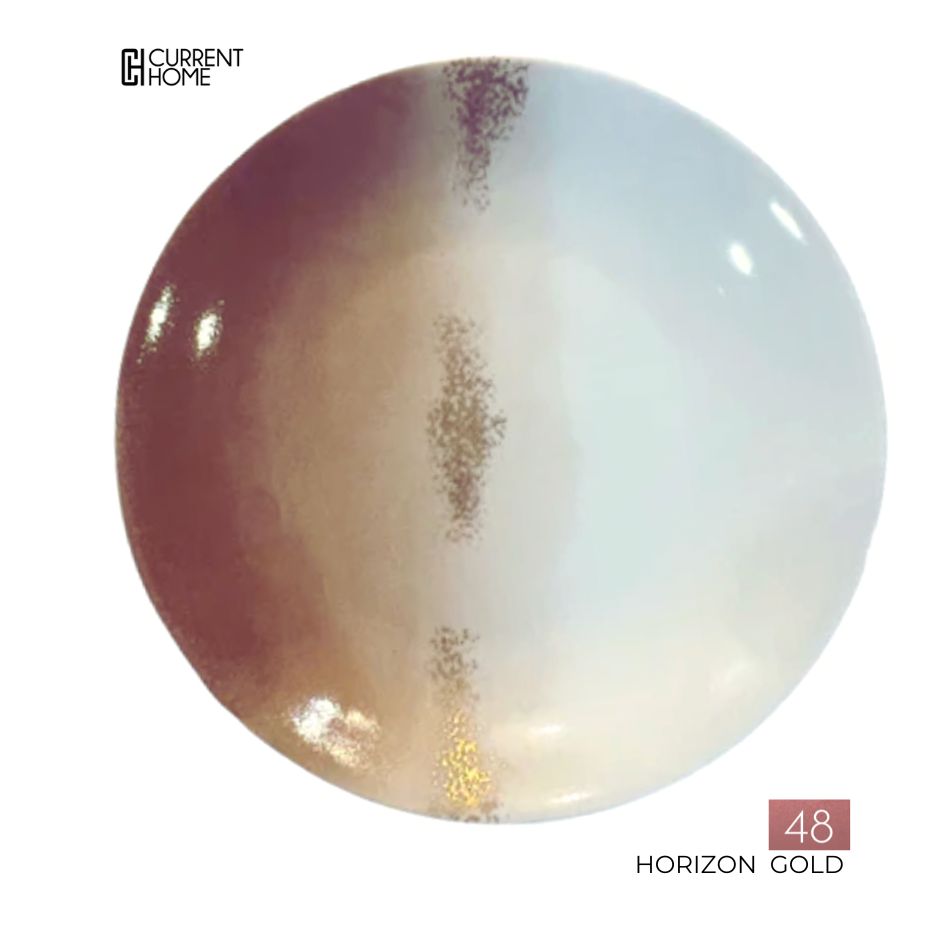 A round porcelain plate by Marie Daâge with a gold, brown, and white gradient design and a central gold stripe. Hand-painted in France. Current Home logo at top left; "48 Horizon Gold" at bottom right. Product: Marie Daâge Horizon Gold Dinnerware.