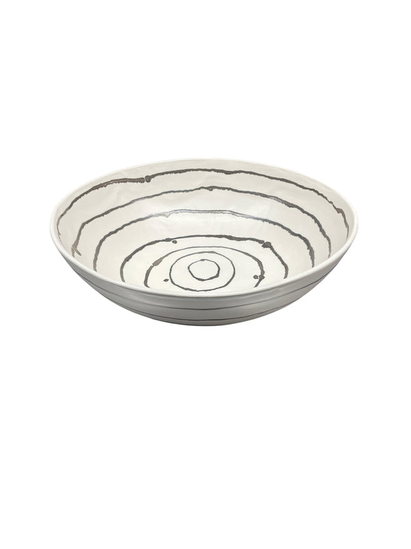 The Linea Serving Bowl - XLarge by Michael Wainwright is a shallow, white ceramic bowl featuring a pattern of irregular, concentric black rings on the inside surface, shown against a plain white background.