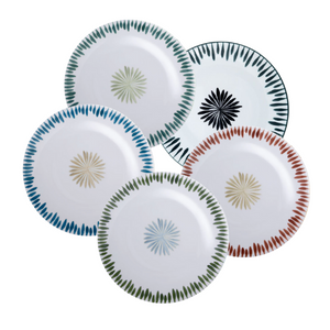 Four white ceramic plates with platinum rims, from Marie Daâge's Allee de Cypres 4 Platinum Rim collection, showcase the artistry of hand painted Limoges dinnerware and the elegance of luxury French tableware.