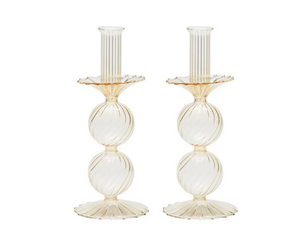 The Bella Candlestick Holder Set of 2 by Kim Seybert showcases two elegant candlestick holders crafted from hand-blown glass, featuring ribbed, spherical shapes stacked vertically and a fluted base, displayed against a plain white background.