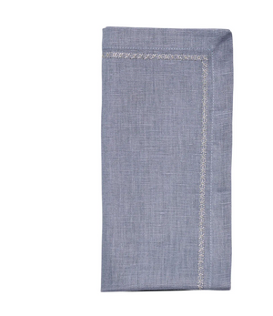 The Kim Seybert Classic Napkin - Dusty Blues (Set of 4) features a folded light blue cloth with a decorative stitched border, shown against a white background.