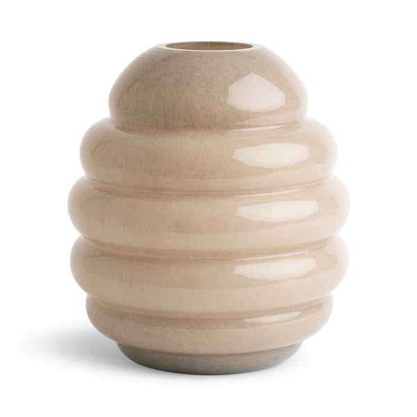 The Tristan Vase by FlowDecor Inc. is a sculptural, beige glass vase featuring a rounded, multi-tiered beehive shape that brings a modern luxury aesthetic to refined interiors.