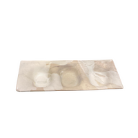 The Three Part Stone Rectangle Platter by Alex Marshall Studios features shallow compartments and a marbled beige and white design on handmade ceramic, offering a smooth, elegant surface.