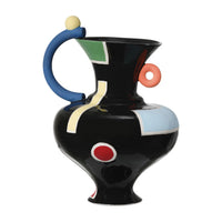 The Matisse Vase - Medium by Currey & Company is a glossy black porcelain piece featuring bold geometric patterns, a curved blue handle, yellow ball top, and red ring—a surrealist statement for modern decor.