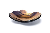 The Mapa Bowl - Bronze by Gardeco is a shallow, bowl-shaped glass dish featuring layered brown, amber, and black tones reminiscent of natural rock or agate patterns, making it a luxurious accent piece when displayed against a white background.