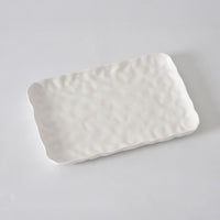 The PAMPA BAY Willow White Platter Rectangle features a textured, wavy surface and slightly raised, uneven edges, showcased on a plain white background.