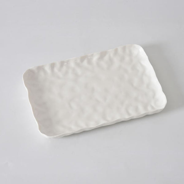 The PAMPA BAY Willow White Platter Rectangle features a textured, wavy surface and slightly raised, uneven edges, showcased on a plain white background.
