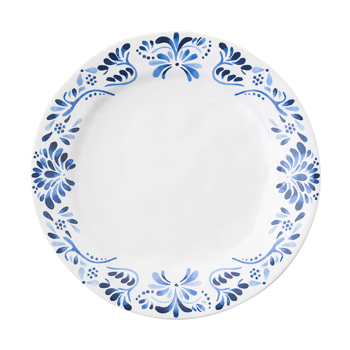 The Juliska Iberian Dinnerware features a round white ceramic dinner plate adorned with a blue floral and leaf pattern inspired by cobalt blue Iberian Journey tiles on a plain white background.