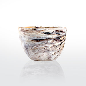 The Nashi Home Swirl Colored Resin Deep Bowl features a marbled pattern in white, beige, brown, and black, shown on a plain white background with a subtle reflection underneath.