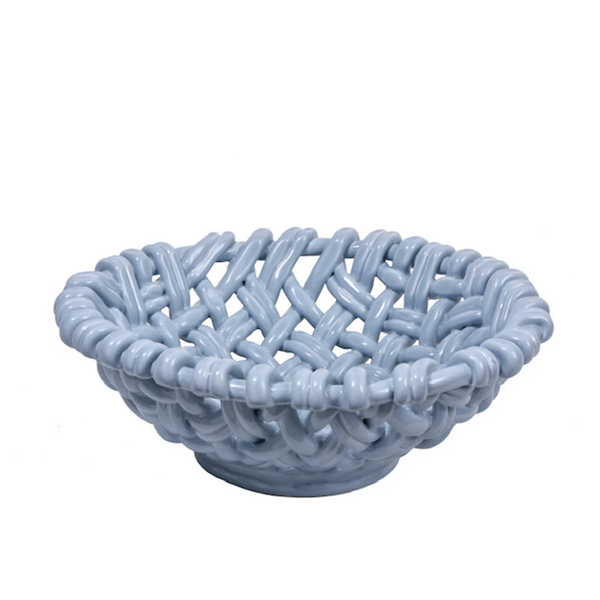 The Skyros Woven Basket - Round-15" is a light blue ceramic bowl with a matte finish and lattice-style design, evoking a handwoven basket. Crafted by Portuguese artisans, it's shown empty against a white background.