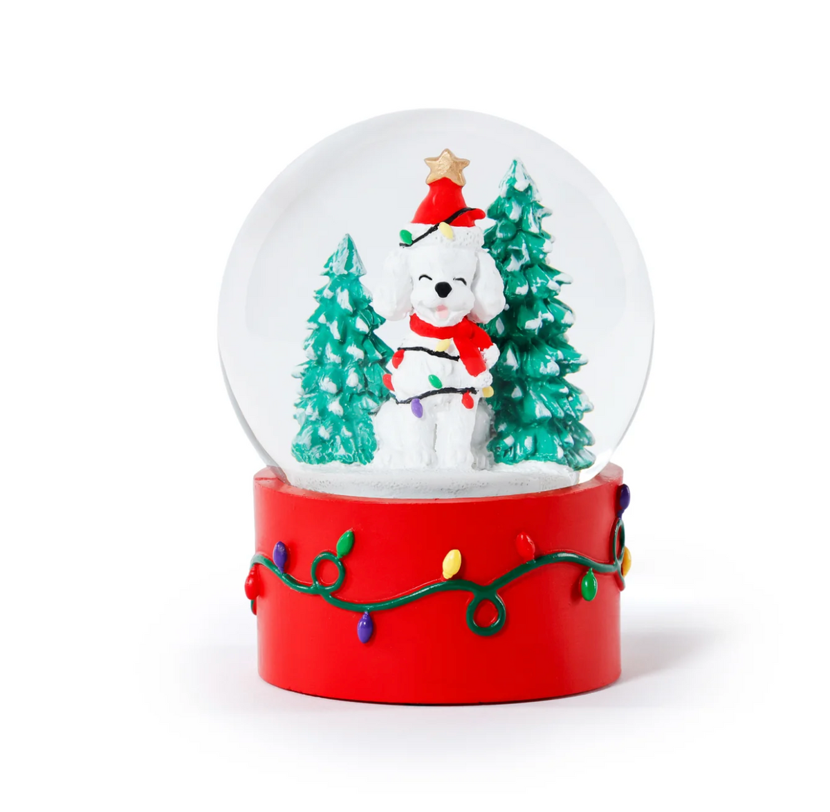 Zodax Dog Snow Globe featuring a white dog in a Santa hat and scarf, surrounded by two evergreen trees on a red base decorated with colorful string lights.