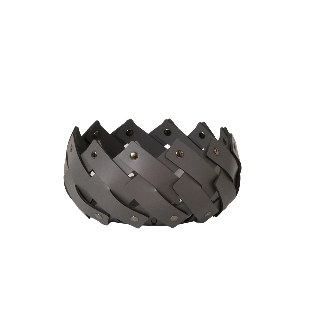 The dark grey mini basket is made of leather and woven and held by dark bronze hardware. 