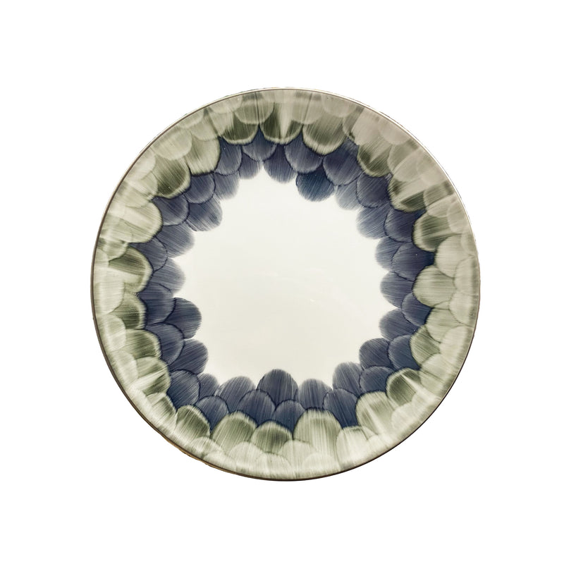 The Marie Daâge Cercle d'Ecailles Dessert Plate features a white center and a rim decorated with hand-painted green and blue brushstroke patterns—a refined Limoges porcelain piece by Marie Daâge.