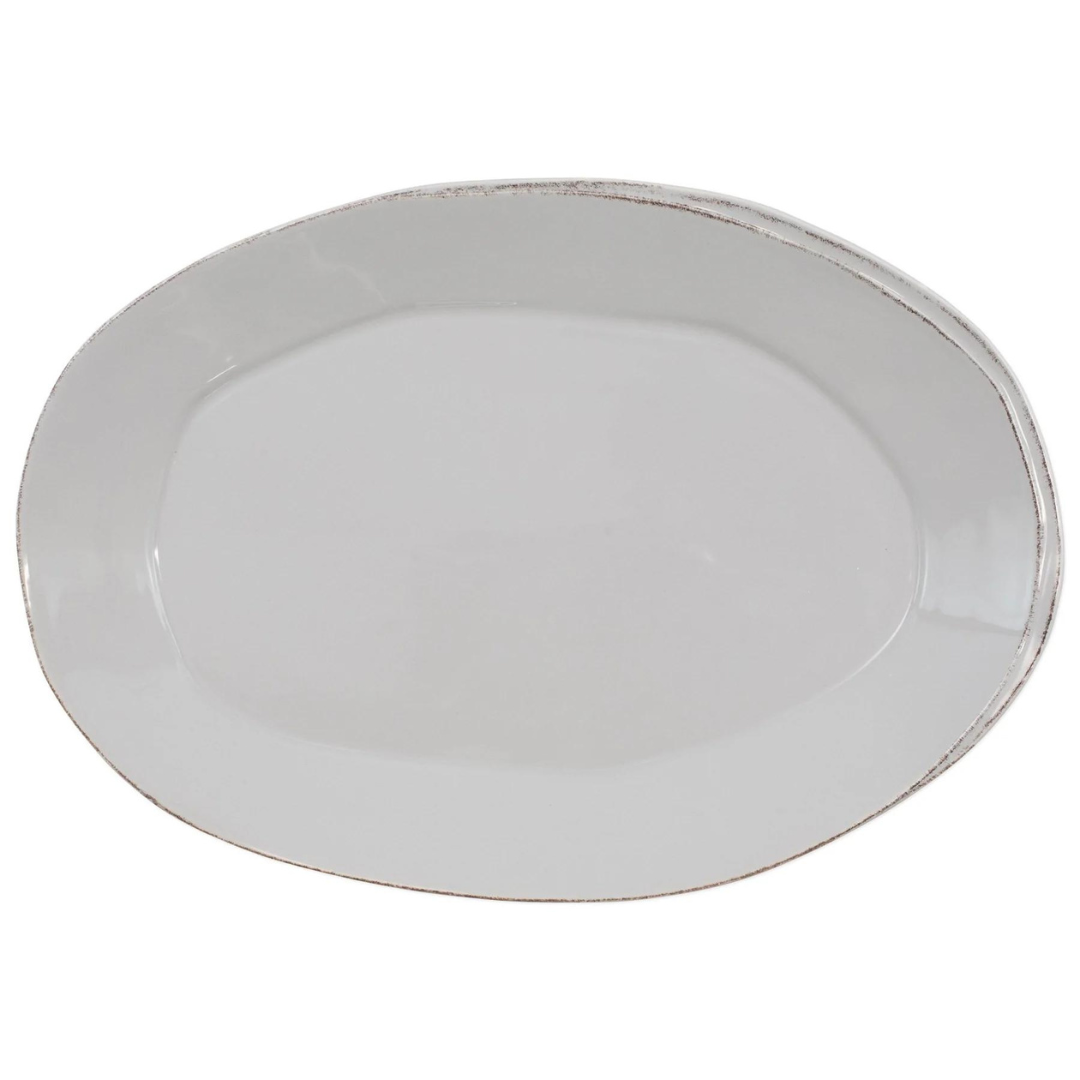 This oval stoneware platter is made in light grey and has an organic shape.