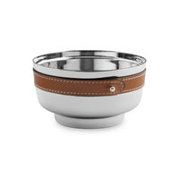 The Nambe Tahoe Nut Bowl features shiny stainless steel and a brown leather strap with white stitching—an elegant, modern barware accessory.