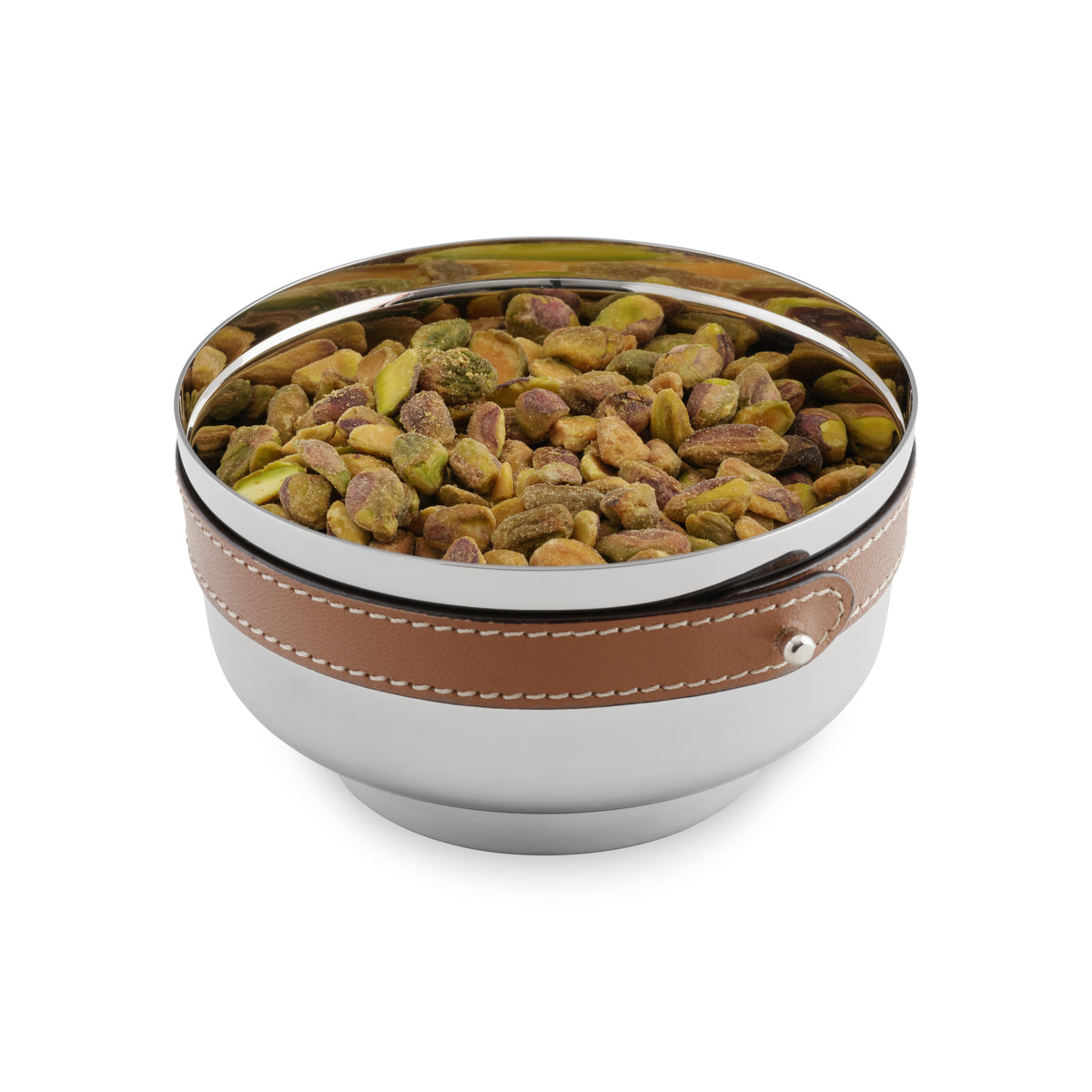 The Nambe Tahoe Nut Bowl features stainless steel barware with a brown leather band, filled with unshelled pistachios and set against a white background.