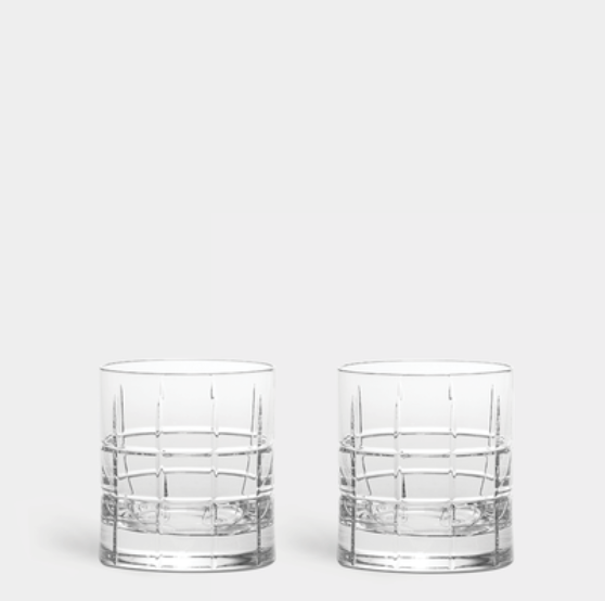 Two Orrefors Kosta Boda Street DOF Glasses from the Set of 2, featuring a grid-like etched pattern, are placed side by side on a plain light gray background.