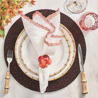 Knotted edge napkins in white, natural, and orange.
