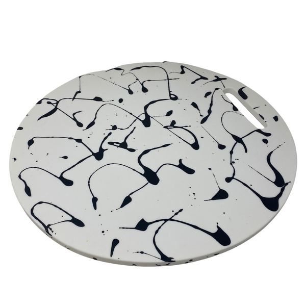 White solid and black splattered resin chopping board. 