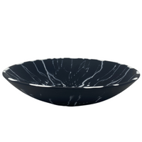 Black solid resin and white splattered bowl.