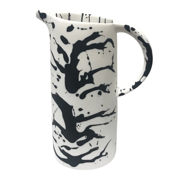 White solid and black splatter resin pitcher. 