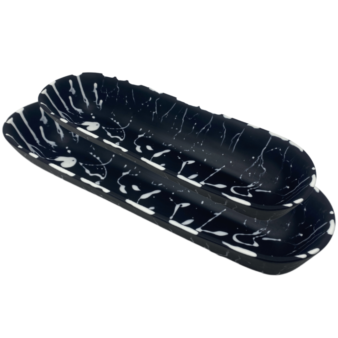 Large and medium black solid and white splattered boat bowls.