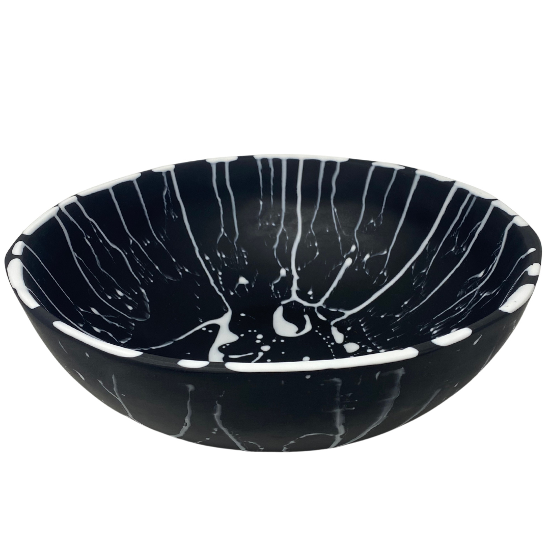 Black solid resin with white splatter on bowl.