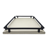 Cream leather tray with four black handles. 