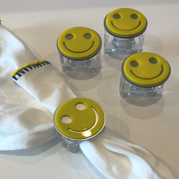 Napkin rings with yellow smiley faces on them. 