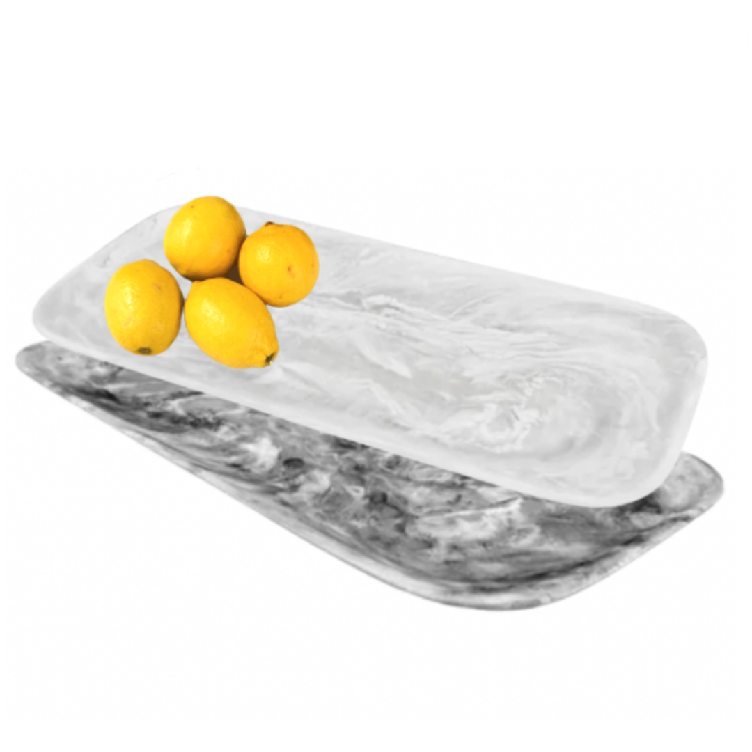 Black and white swirl rectangular serving platters with lemons on top. 