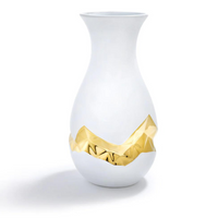 The oro gold vase is made of white ceramic and has a gold painted 3D geometric center. 